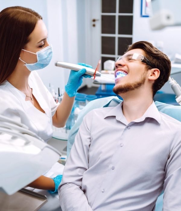 young-man-at-the-dentist-s-chair-during-a-dental-procedure-overview-of-dental-caries-prevention--1536x1025